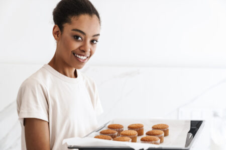 Positive woman cooking at the kitchen at home