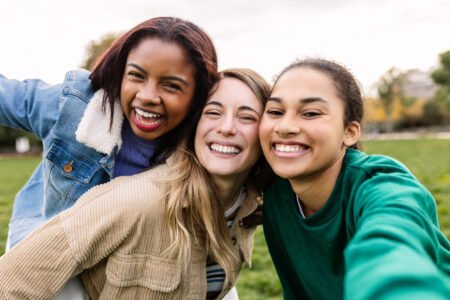 multi ethnic group of three young women taking